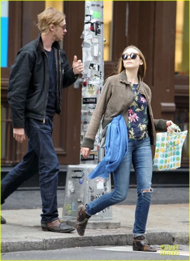 bitchy | Elizabeth Olsen holding hands with a mystery guy out for a walk in New York