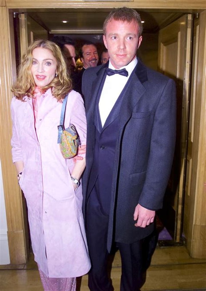 	Madonna and Guy holding on until her tour rakes in the dough	